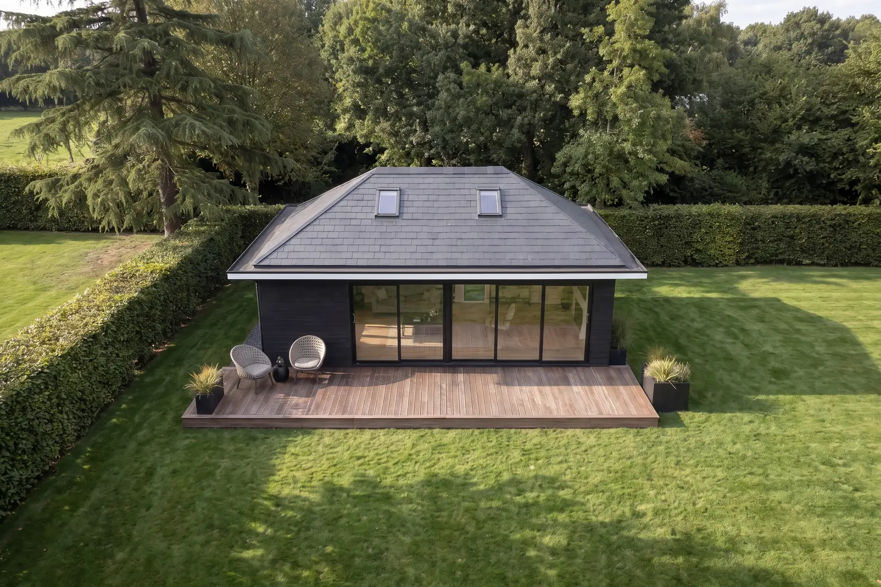 Aerial view of a detached NuaHome garden home, its hipped warm roof and two rooflights